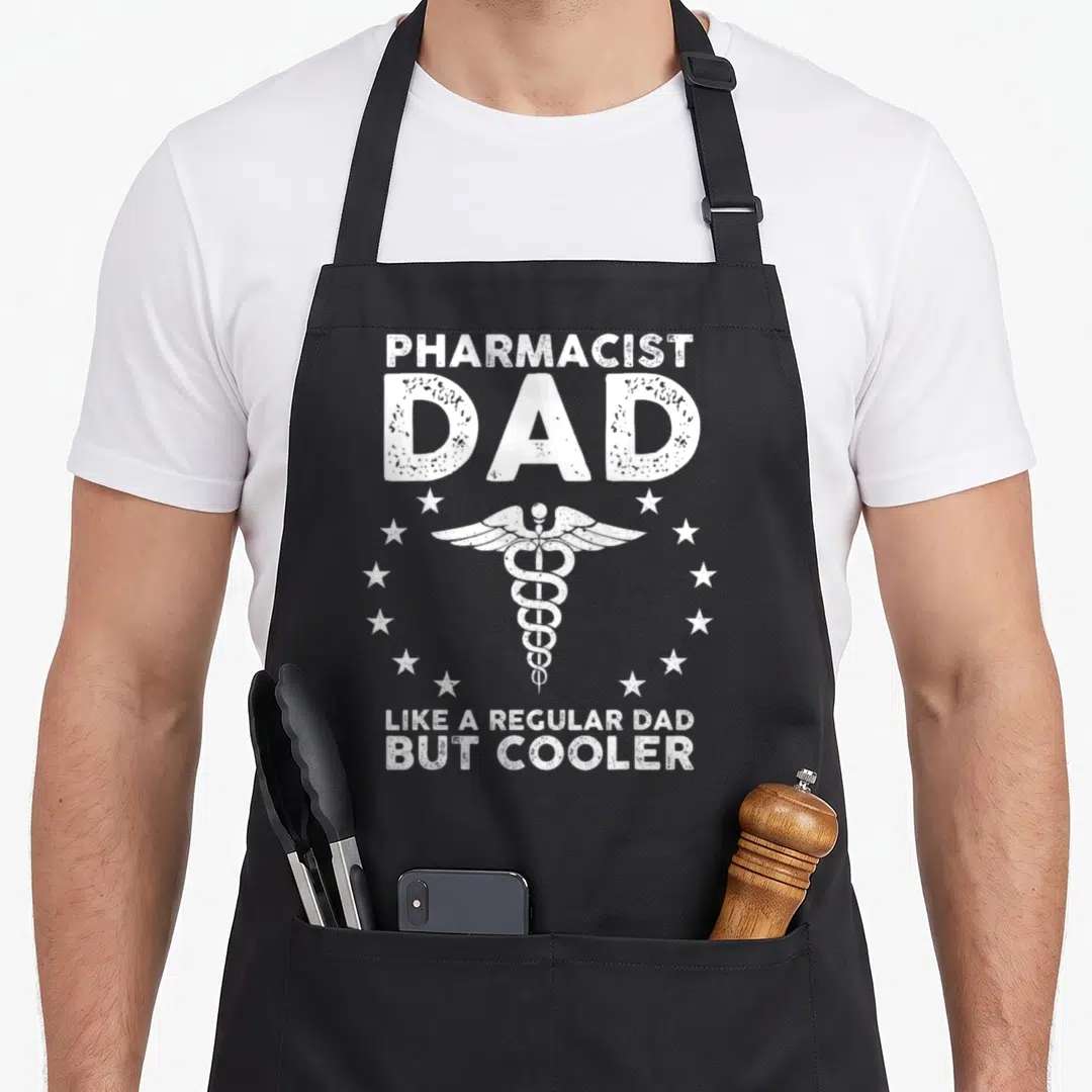 School pharmacy pharmacist apron - White distressed PHARMACIST DAD text and caduceus surrounded by stars — shown on a black cotton canvas apron against a white background