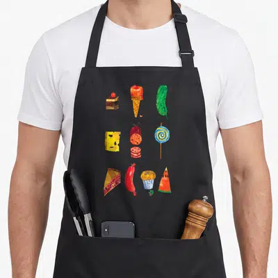 Retro food aprons - Watercolor food grid with cake, ice cream, cheese, salami, lollipop, cupcake, and small green — shown on a black cotton canvas apron against a white background