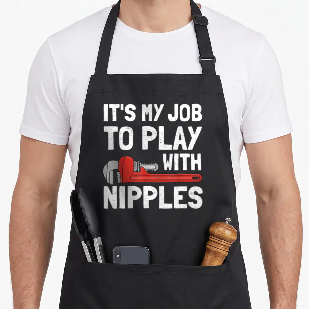 Steamfitter pipefitter apron - Red pipe wrench graphic with white distressed text reading IT'S MY JOB TO PLAY — shown on a black cotton canvas apron against a white background