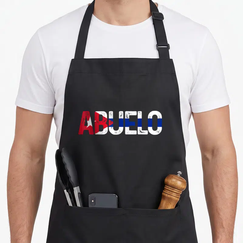 Abuelo father day apron - ABUELO text filled with red white and blue Cuban flag stripes in distressed font — shown on a black cotton canvas apron against a white background