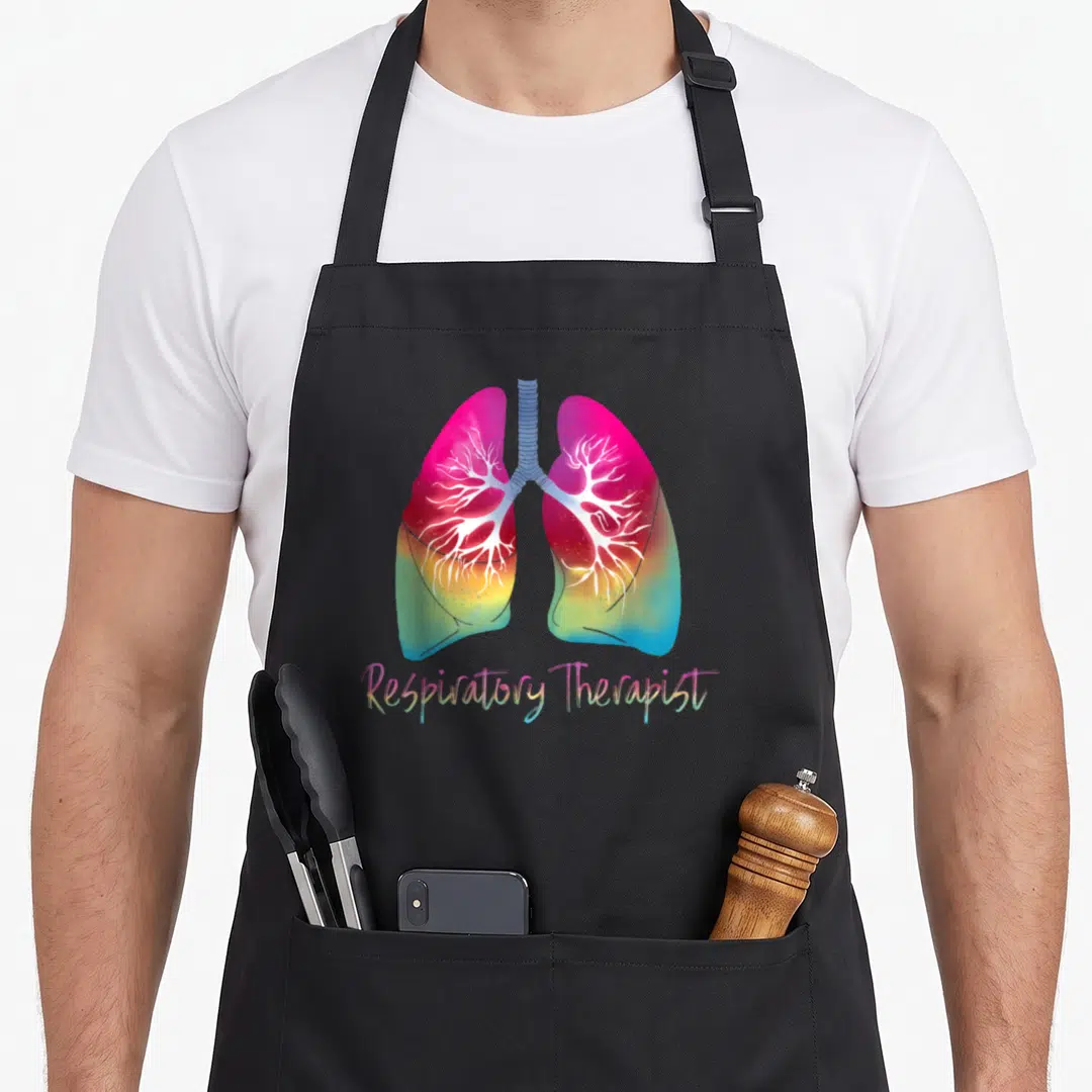 Respiratory colorful aprons - Rainbow gradient lungs with white bronchial trees and script text — shown on a black cotton canvas apron against a white background