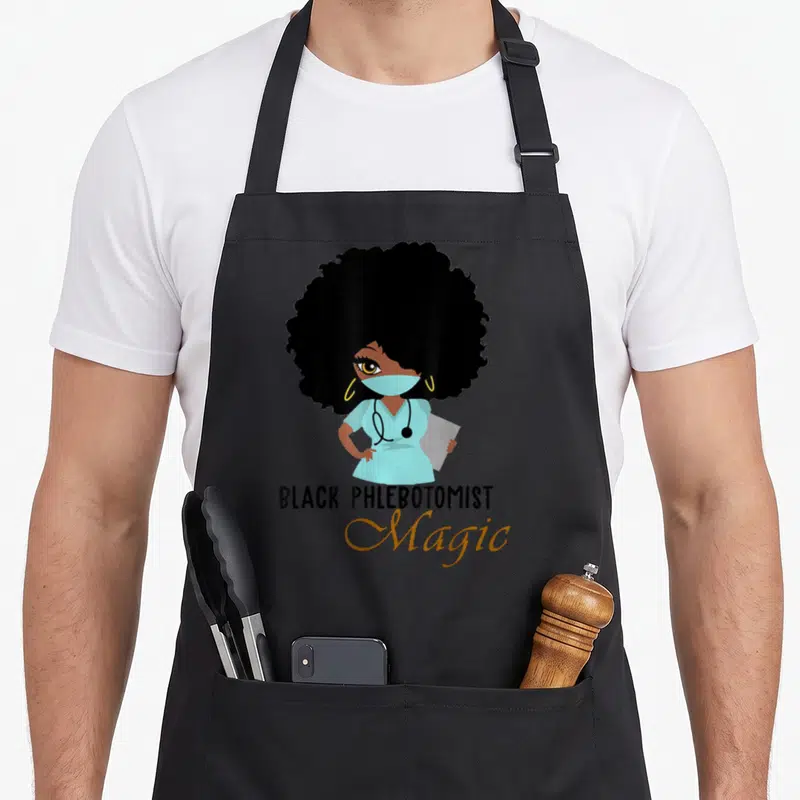 Phlebotomist magic apron - Cartoon woman in blue scrubs and mask with text BLACK PHLEBOTOMIST Magic below — shown on a black cotton canvas apron against a white background