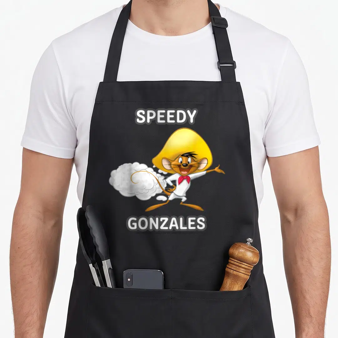 Gonzale looney tune apron - Speedy Gonzales mouse in yellow sombrero with dust cloud and bold text — shown on a black cotton canvas apron against a white background