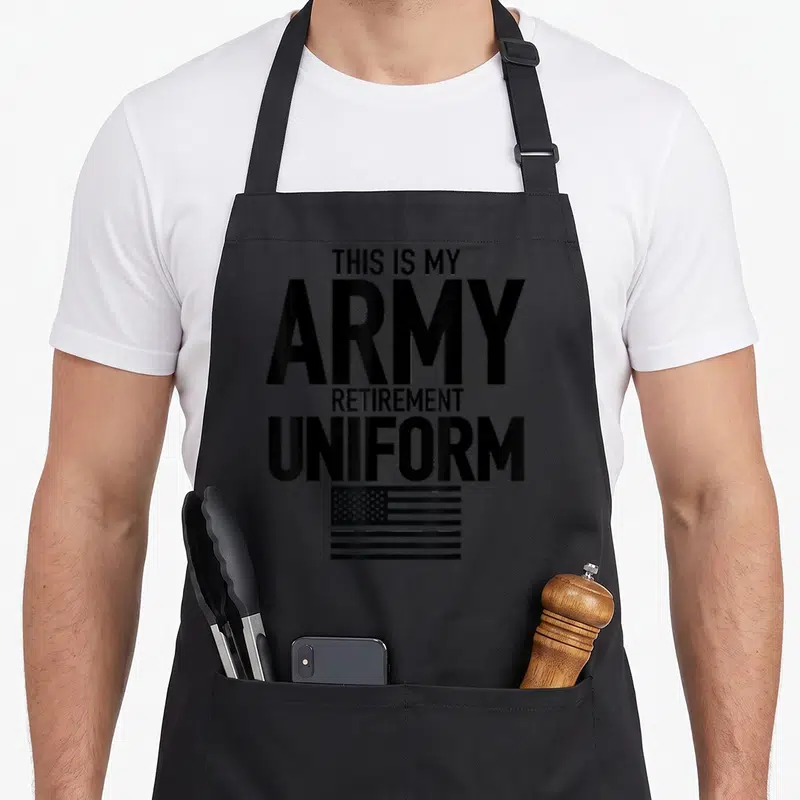 Army uniform apron - Stacked text THIS IS MY ARMY RETIREMENT UNIFORM above black and white flag — shown on a black cotton canvas apron against a white background