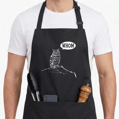 Whom teacher apron - White owl on rock with speech bubble reading WHOM in line art style — shown on a black cotton canvas apron against a white background
