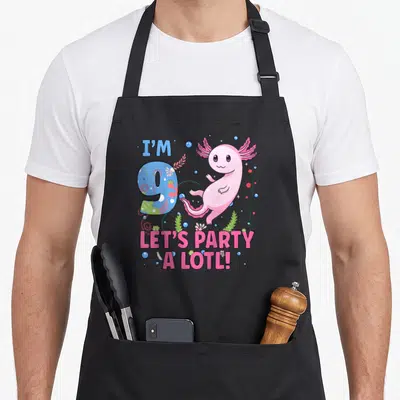 Motif birthday apron - Pink axolotl next to number 9 with bubbles and text I'M 9 LET'S PARTY A LOTL — shown on a black cotton canvas apron against a white background