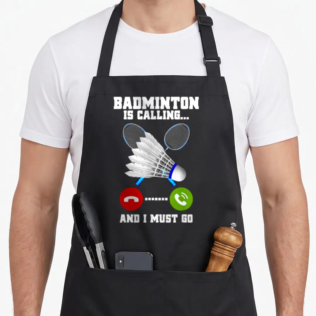 Calling badminton apron - Crossed rackets shuttlecock red decline green accept buttons and white text on black — shown on a black cotton canvas apron against a white background