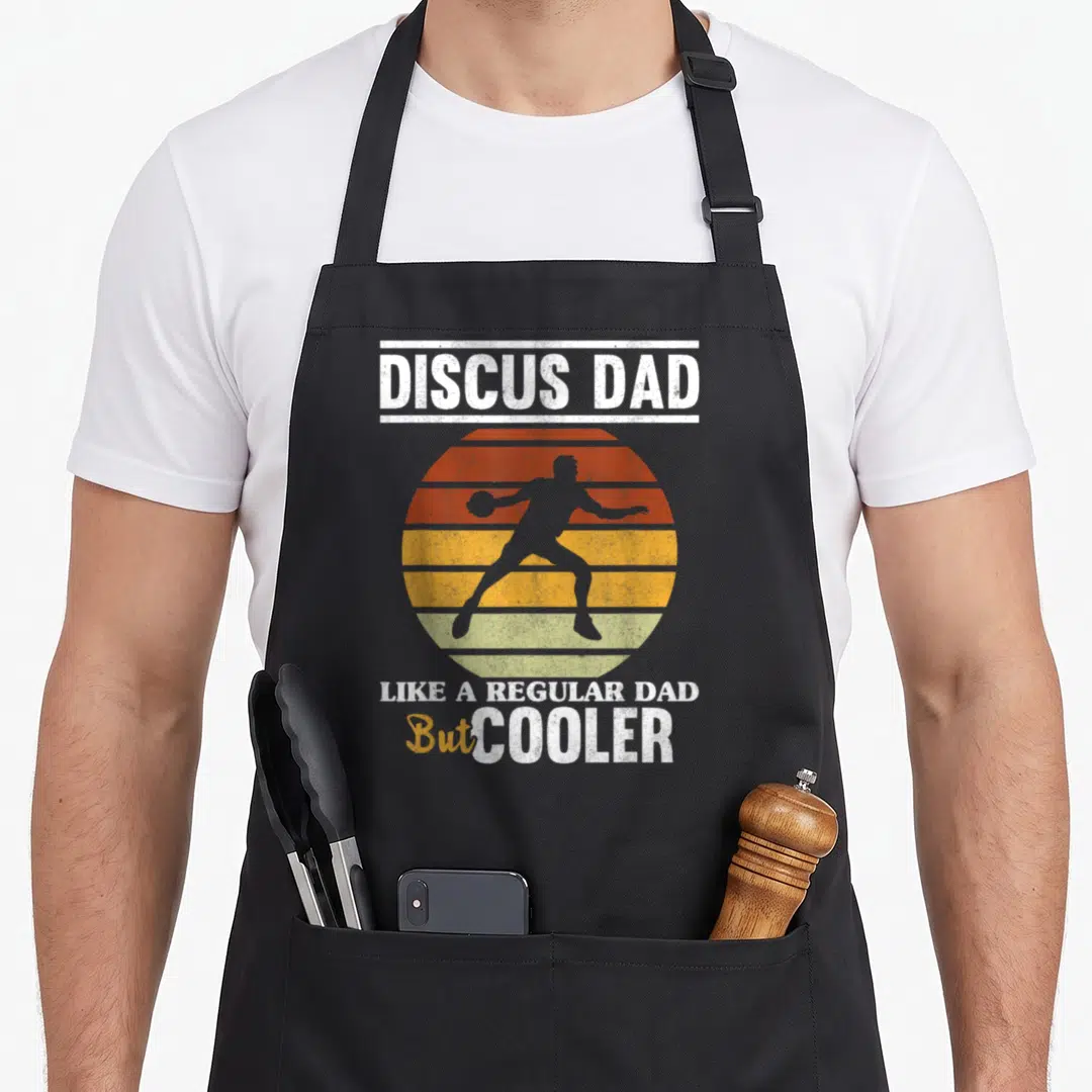Thrower field track apron - Grey discus thrower silhouette over orange yellow striped sun with white and yellow text — shown on a black cotton canvas apron against a white background