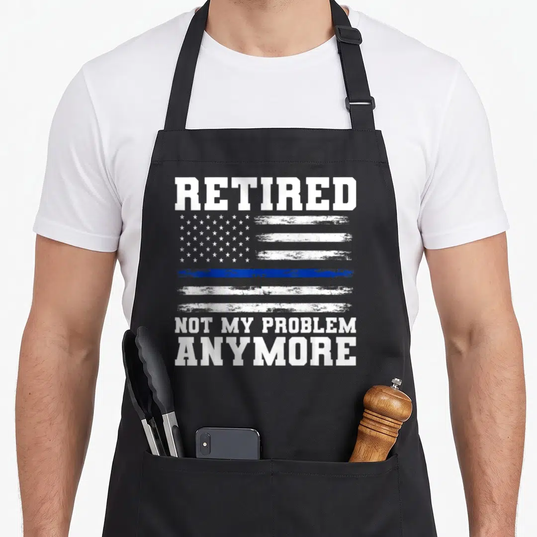 Anymore police apron - Distressed USA flag with thin blue line and text Retired Not My Problem Anymore — shown on a black cotton canvas apron against a white background