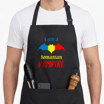 Patriotic romanian apron - Bat in blue yellow red stripes with text I am a Romanian VAMPIRE — shown on a black cotton canvas apron against a white background