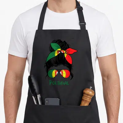 Bandana portuguese apron - Woman silhouette with bandana and sunglasses in Portuguese flag colors, PORTUGAL text below — shown on a black cotton canvas apron against a white background