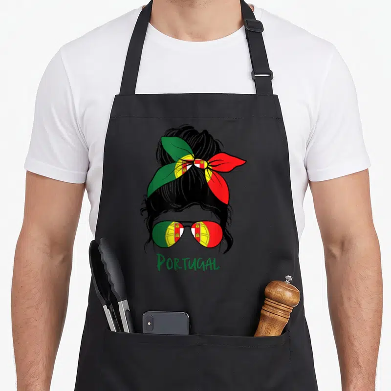 Bandana portuguese apron - Woman silhouette with bandana and sunglasses in Portuguese flag colors, PORTUGAL text below — shown on a black cotton canvas apron against a white background