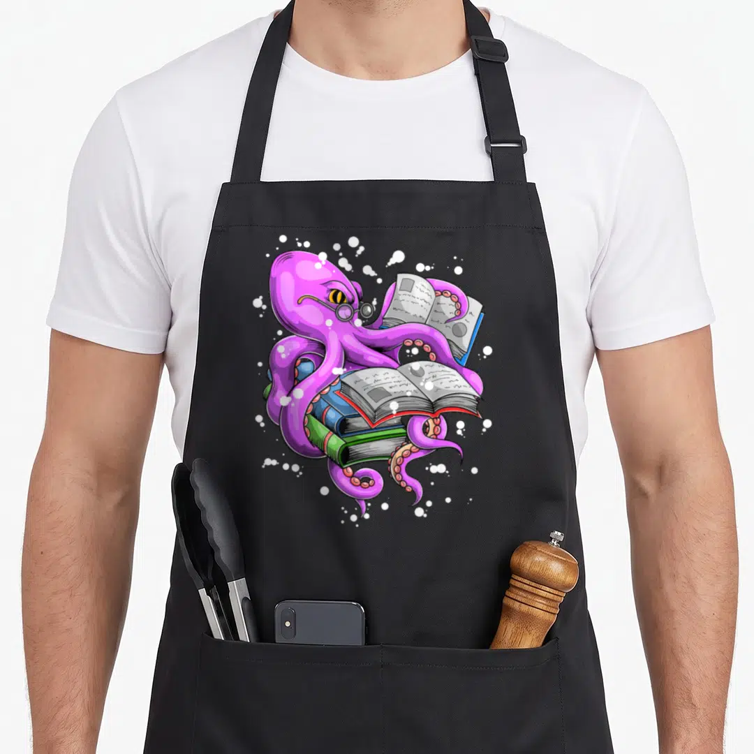 Octopus cartoon apron - Purple cartoon octopus with glasses holding three stacked books — shown on a black cotton canvas apron against a white background