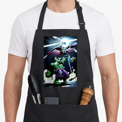 Battle universe apron - Thor leaping with hammer above green Hulk standing in purple pants and smoke — shown on a black cotton canvas apron against a white background