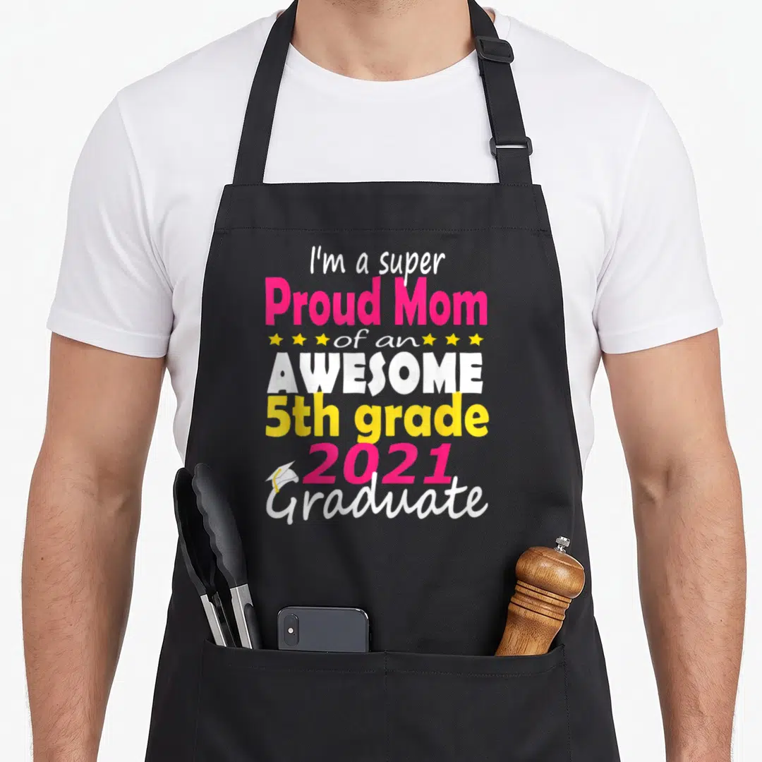 Proud come and get it apron - Stacked text Proud Mom 5th grade 2021 Graduate with small cap and yellow stars — shown on a black cotton canvas apron against a white background