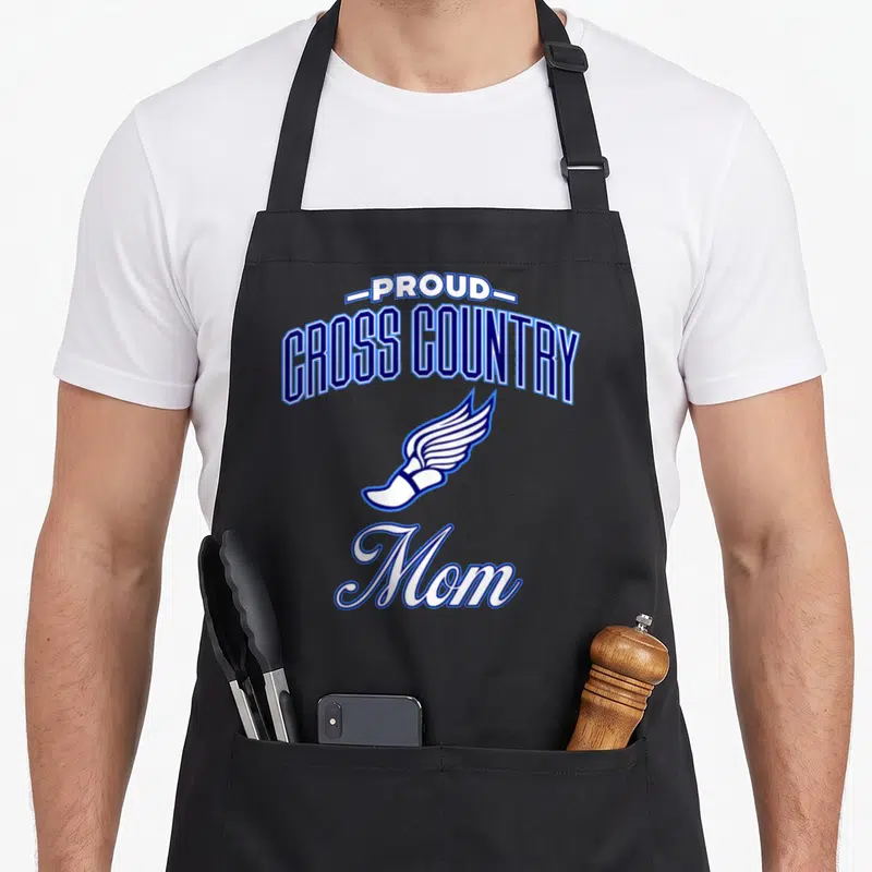 Retro cross country apron - PROUD CROSS COUNTRY Mom text with winged foot in blue and white on black — shown on a black cotton canvas apron against a white background