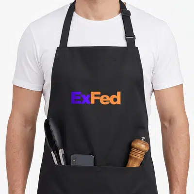 Government green cheek apron - ExFed text in purple and orange block typography on black background — shown on a black cotton canvas apron against a white background