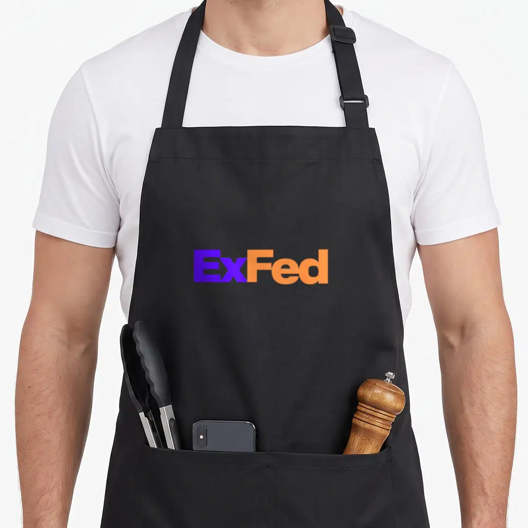 Government green cheek apron - ExFed text in purple and orange block typography on black background — shown on a black cotton canvas apron against a white background