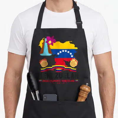 Venezuelan chef outfit with apron - Map of Venezuela filled with flag colors, arepas, purple orchid, ribbons — shown on a black cotton canvas apron against a white background