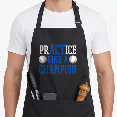Practice baseball apron - Blue and white text reading Practice Like A Champion flanked by two red-stitched baseballs — shown on a black cotton canvas apron against a white background