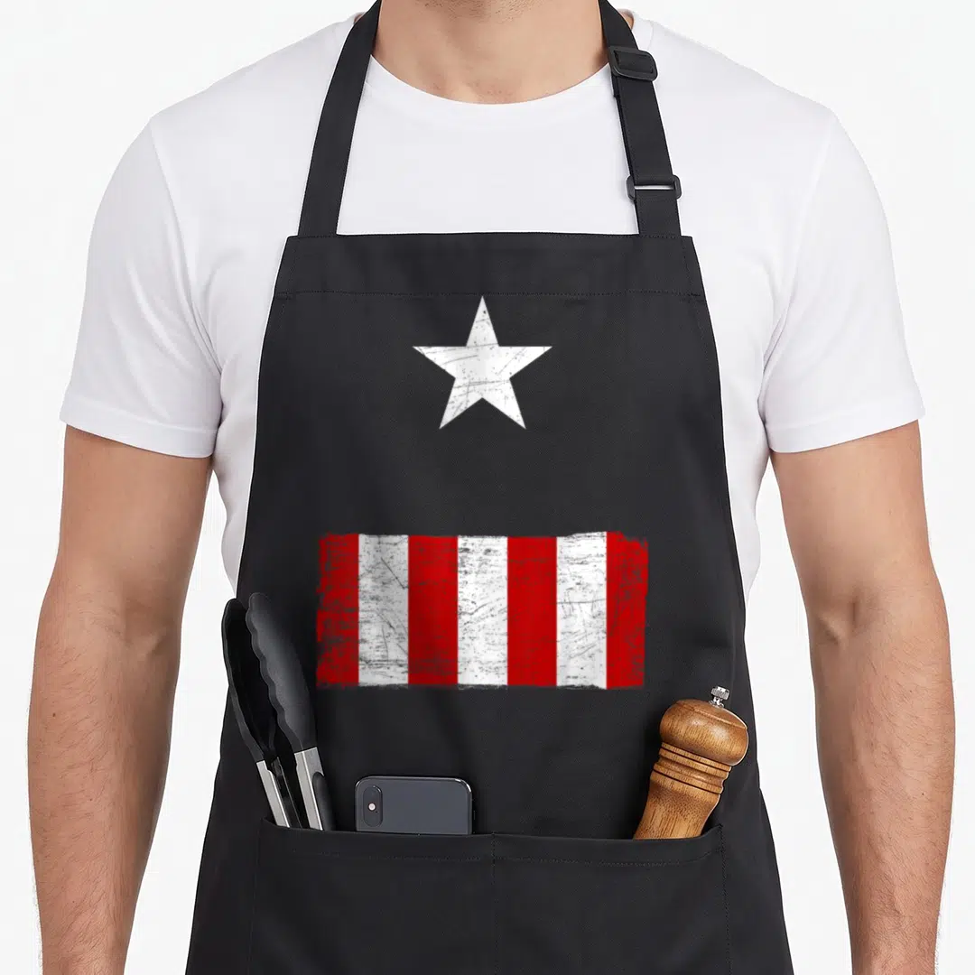 Retro hobby halloween apron - Distressed white star above red and white vertical stripes on canvas — shown on a black cotton canvas apron against a white background