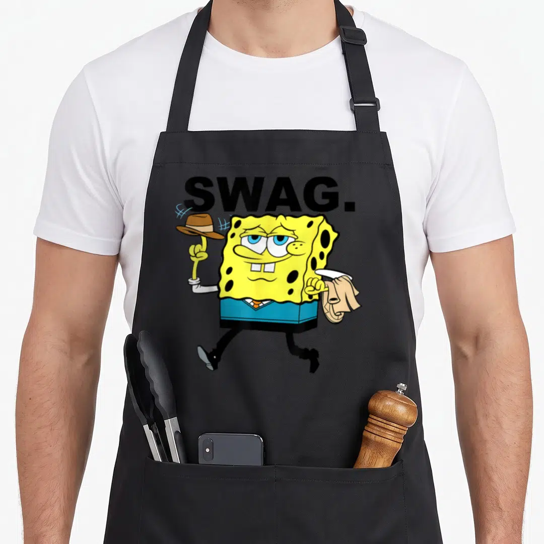 Squarepant worlds greatest apron - SpongeBob SquarePants character tipping hat under black SWAG text in yellow and blue — shown on a black cotton canvas apron against a white background