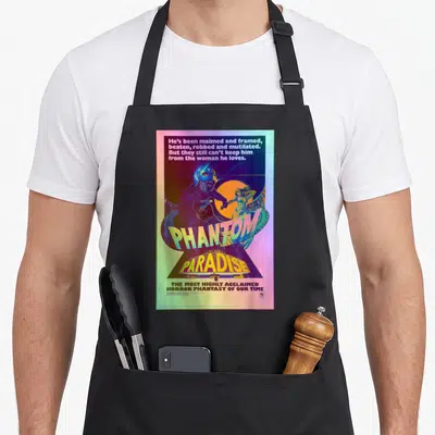 Movie rock apron - Phantom of the Paradise poster with masked monster woman sun and retro text blocks in purple yellow — shown on a black cotton canvas apron against a white background