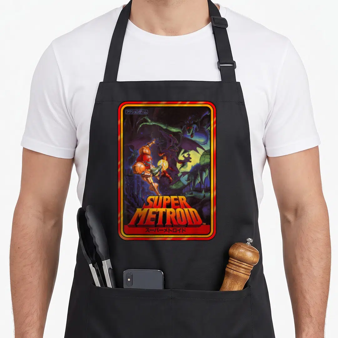 Kanji asteroid apron - Super Metroid box art with Samus Aran, dragon, and Japanese text in red frame — shown on a black cotton canvas apron against a white background