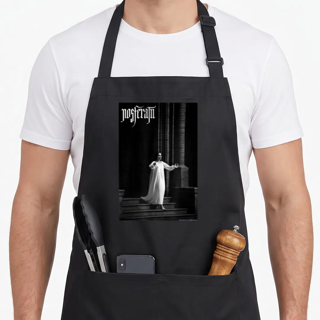 Nosferatu gothic apron - Gothic text above a woman in a white dress standing on stone steps between dark pillars — shown on a black cotton canvas apron against a white background