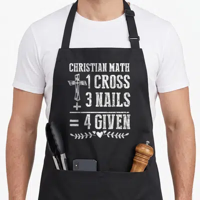 Math christian apron - White distressed text 1 Cross 3 Nails 4 Given with cross and vine graphic — shown on a black cotton canvas apron against a white background