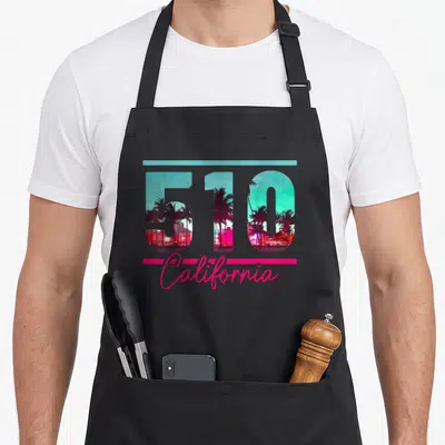 Dialling richmond california apron - 510 number with palm tree landscape inside, teal line above, pink California — shown on a black cotton canvas apron against a white background