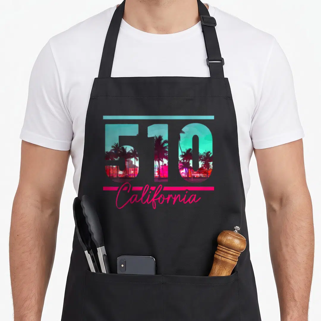 Dialling richmond california apron - 510 number with palm tree landscape inside, teal line above, pink California — shown on a black cotton canvas apron against a white background