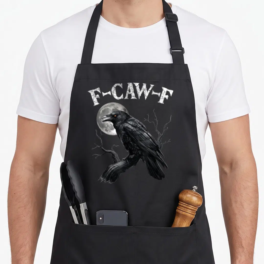 Bird gothic apron - F-CAW-F text above a black crow perched on a branch in front of a moon — shown on a black cotton canvas apron against a white background