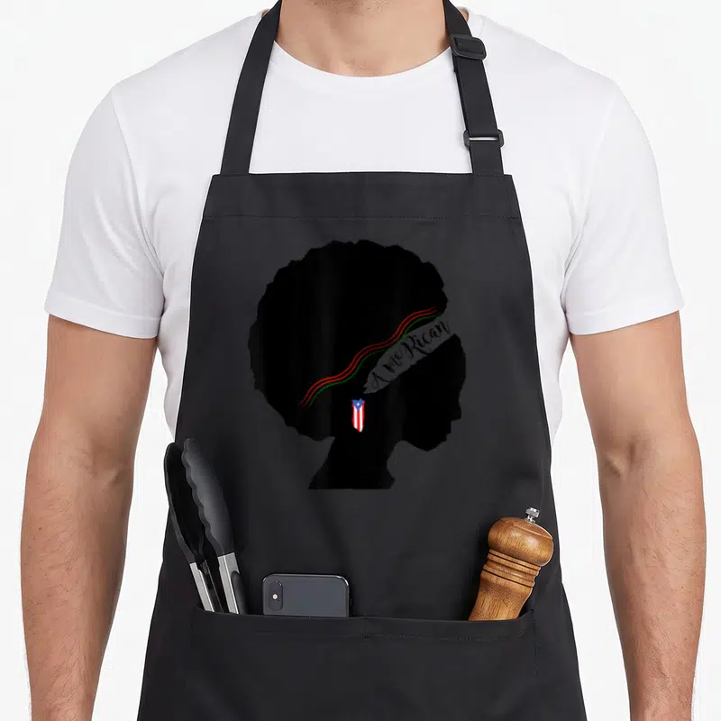 Afro rican pride apron - Black woman silhouette with red green stripes and AmeRican text and Puerto Rican flag — shown on a black cotton canvas apron against a white background