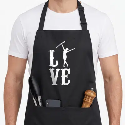 Rifle color guard apron - White LIVE text with woman silhouette holding rifle aloft replacing the letter I — shown on a black cotton canvas apron against a white background