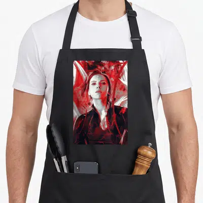Funny endgame painting apron - Realistic woman portrait surrounded by abstract red and white brushstrokes on black — shown on a black cotton canvas apron against a white background