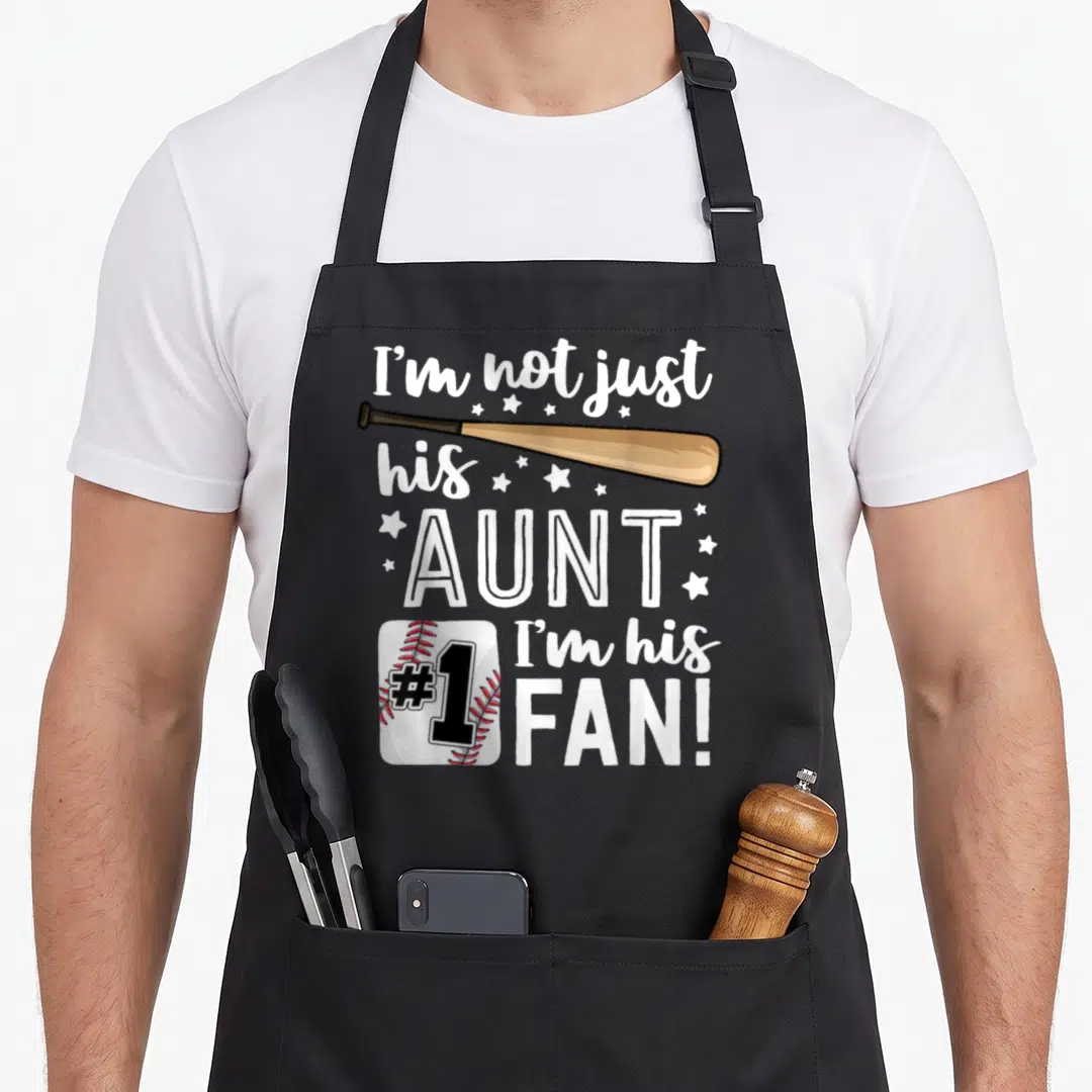 His family aprons - Baseball bat and #1 ball with I'm his AUNT I'm his FAN text and stars — shown on a black cotton canvas apron against a white background