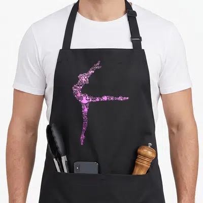 Vintage ballet ballerina apron - Pink silhouette of a ballerina formed by tiny ballet shoes and musical notes — shown on a black cotton canvas apron against a white background