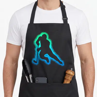 Youth wintersport hockey apron - Grey hockey player silhouette surrounded by a glowing cyan and green aura on a grey — shown on a black cotton canvas apron against a white background