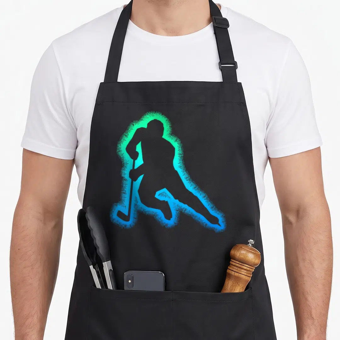 Youth wintersport hockey apron - Grey hockey player silhouette surrounded by a glowing cyan and green aura on a grey — shown on a black cotton canvas apron against a white background