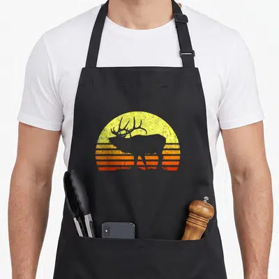 Elk bow apron - Grey elk silhouette against yellow orange and red striped retro sun — shown on a black cotton canvas apron against a white background