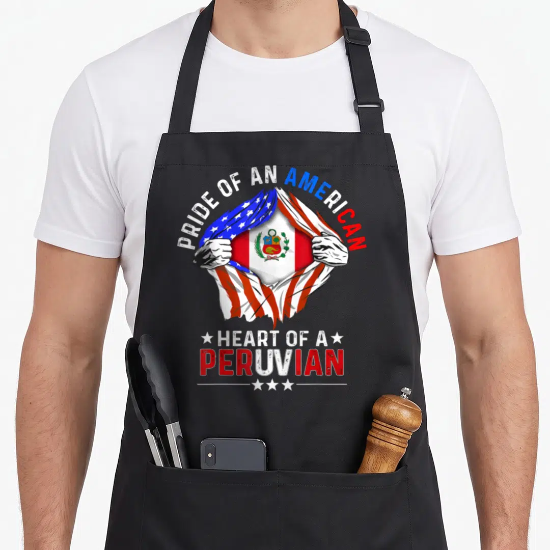 Pride country apron - Hands tearing USA flag to reveal Peru flag with PRIDE OF AN AMERICAN HEART OF A PERUVIAN text — shown on a black cotton canvas apron against a white background
