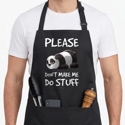 Lazy funny inappropriate by lazypanda apron - Cartoon panda lying down between white text PLEASE DON'T MAKE ME DO STUFF — shown on a black cotton canvas apron against a white background
