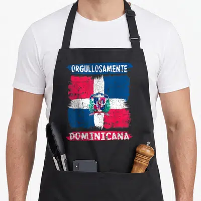Republic the painted apron - Distressed Dominican Republic flag with Orgullosamente Dominicana text and coat of arms — shown on a black cotton canvas apron against a white background