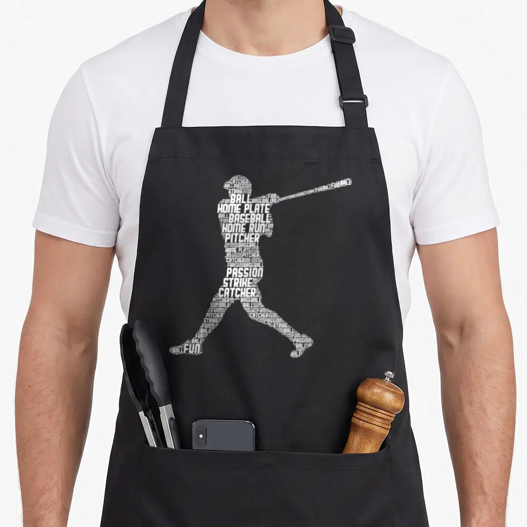 Funny player baseball apron - White typography silhouette of a baseball player formed by words like PITCHER, STRIKE — shown on a black cotton canvas apron against a white background