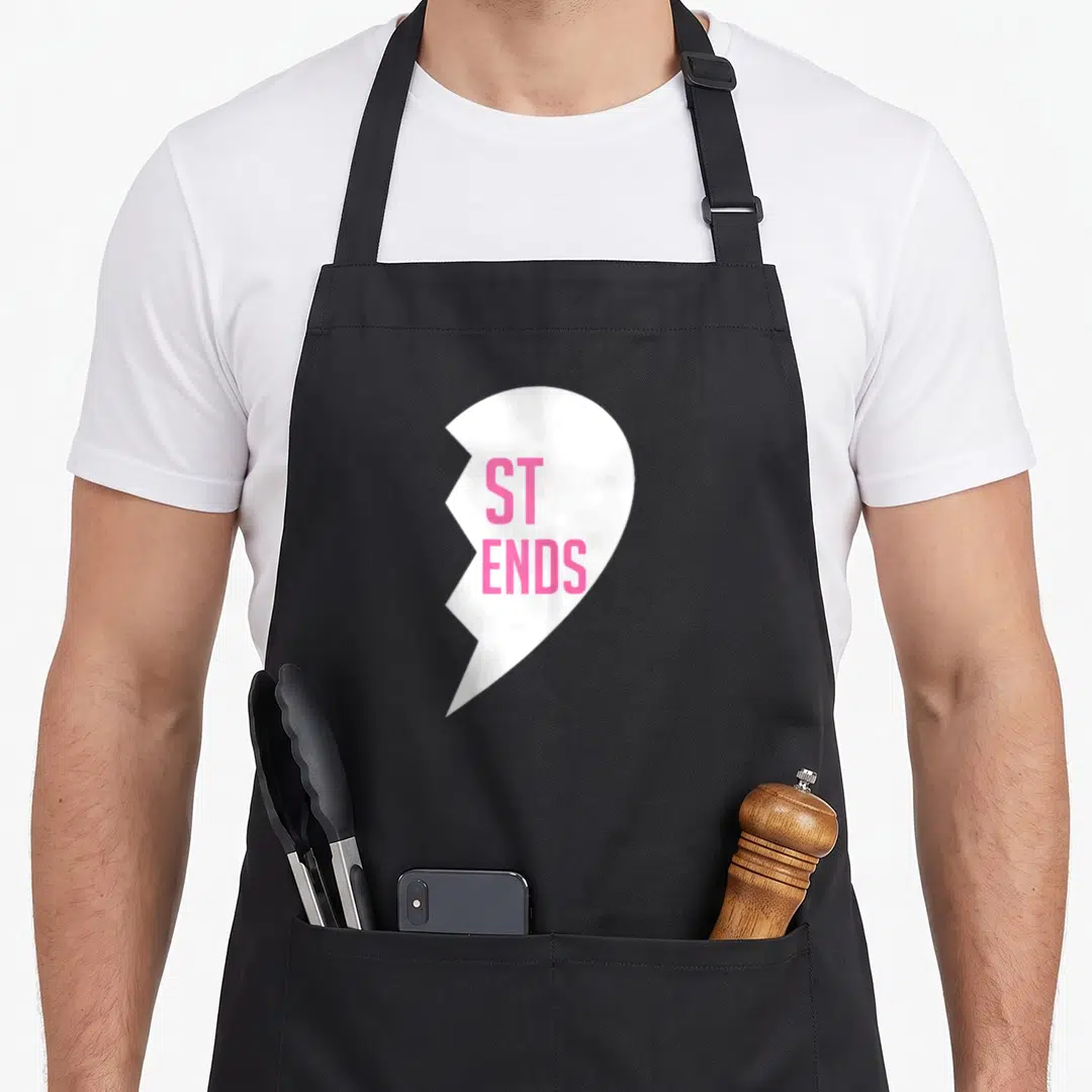 Bff chef outfit apron - White broken heart shape with pink ST ENDS text printed on the front panel — shown on a black cotton canvas apron against a white background