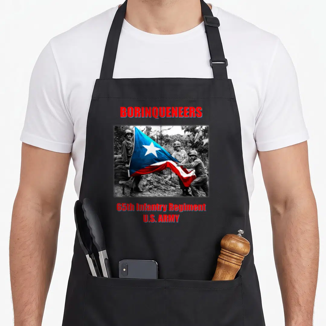 Borinqueneer infantry apron - Three soldiers hold a colored flag in a black and white photo with red and blue text — shown on a black cotton canvas apron against a white background