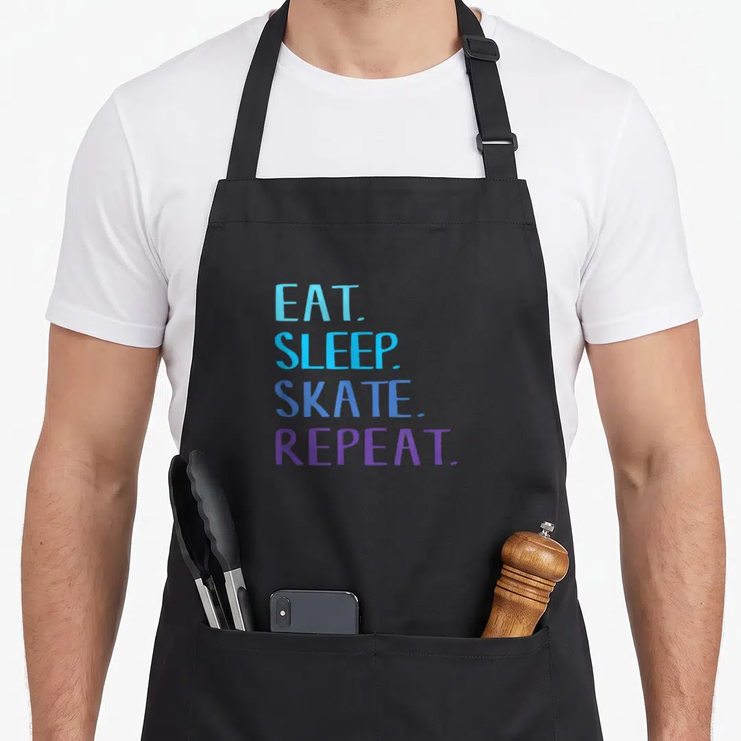 Eat apron or apron - Stacked blue and purple text reading EAT SLEEP SKATE REPEAT — shown on a black cotton canvas apron against a white background