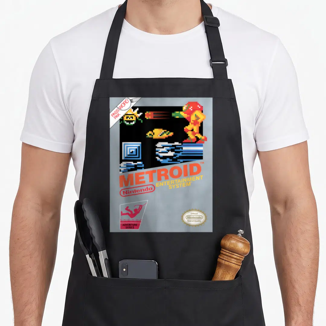 Nes metroidvania apron - Pixel art Metroid box art with Nintendo logo and password pak tag on grey background — shown on a black cotton canvas apron against a white background