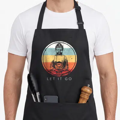 Buddha tibetan boy apron - Distressed Buddha silhouette over white blue yellow orange and red horizontal bands — shown on a black cotton canvas apron against a white background